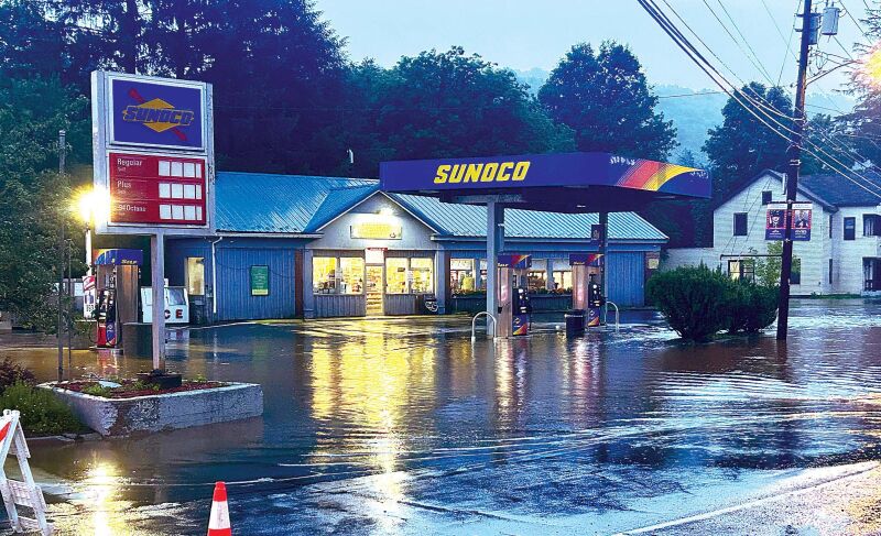 WET DAY By Wednesday morning, waters had begun to recede, though the Sunoco station on Pearl Street was still awash.