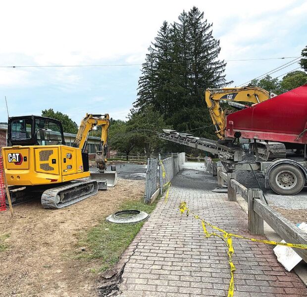 GETTING READY Workers are installing a new fuel tank near the School Street entrance, part of the school’s new heating system.