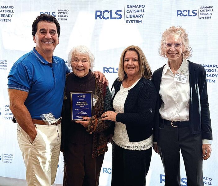 18 YEARS With Marge Feurstein and her award are, from left, son Daniel Feuerstein, Board of Trustees co-President Ellen Pope and Director Peggy McGuire.